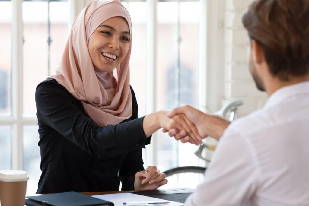 woman shaking hand at job interview 
