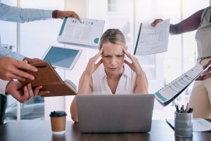 Work stress, headache and burnout mindset of a business woman working at a office computer. Corporate tax employee worried about mental health from job report, contract and compliance data overload.